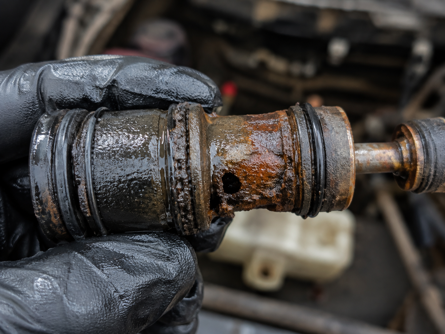 The removed master cylinder showing internal corrosion and failure.