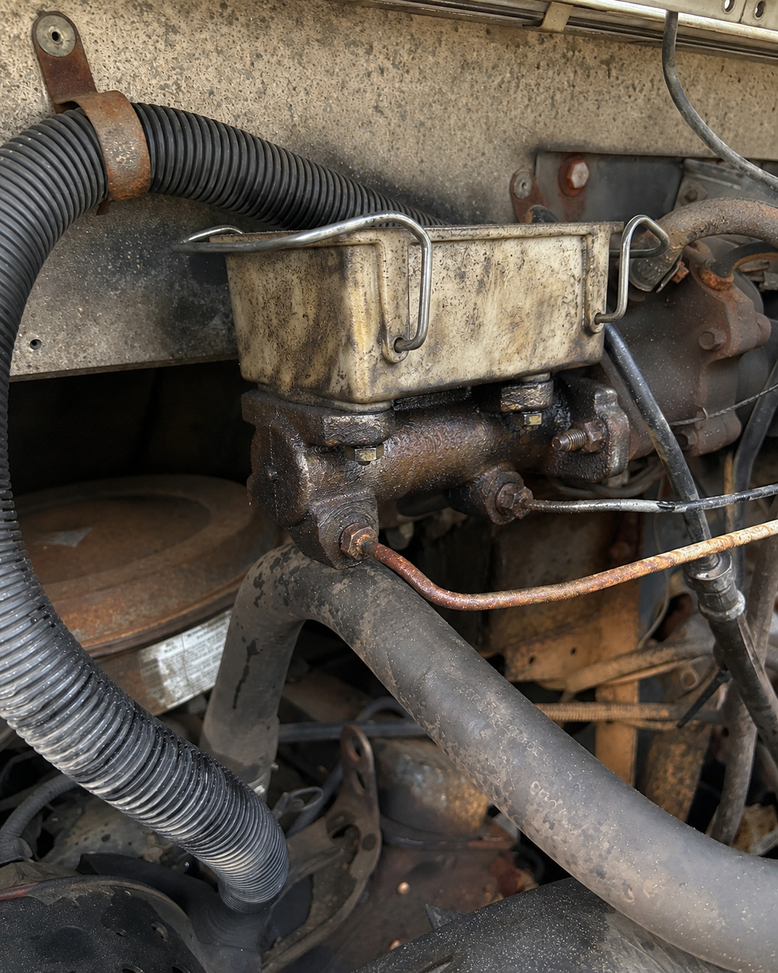 The original brake master cylinder before removal.